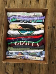 Image shows a box of t-shirts for the first step of making a t-shirt quilt