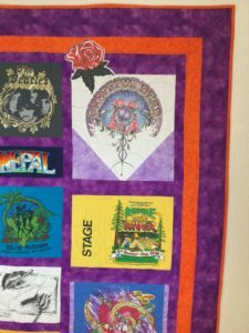 Image of an eclectic custom t-shirt quilt that I made for a customer