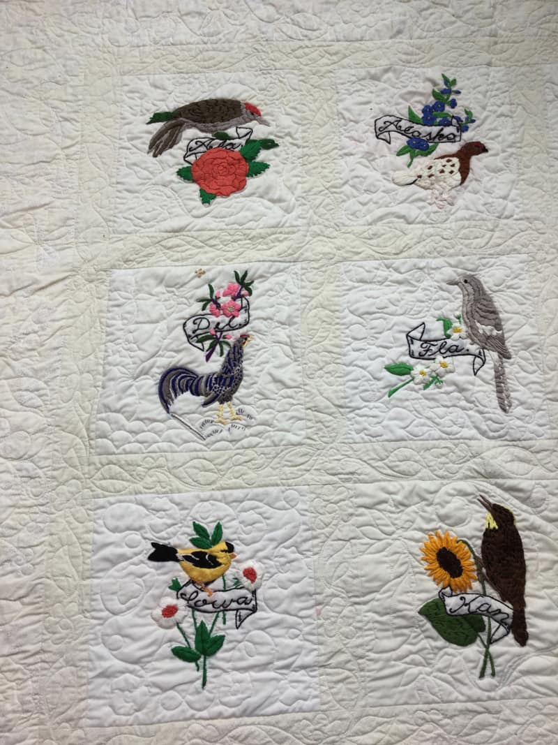 Stitch work of State Birds and Flowers on Quilt