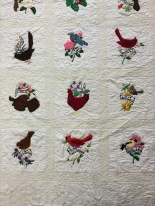 Stitch work of State Birds and Flowers on Quilt