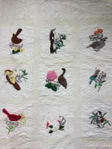 Stitch work of State Birds and Flowers on Quilt