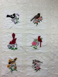 Stitch work of State Birds and Flowers on Quilt